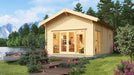 GardenHouse24 USA Sigrid 44 Garden Room is shown in a lakeside setting surrounded by trees and flowers, glowing warmly with interior lights