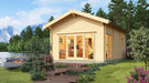 GardenHouse24 USA Sigrid 44 Garden Room is shown in a lakeside setting surrounded by trees and flowers, glowing warmly with interior lights