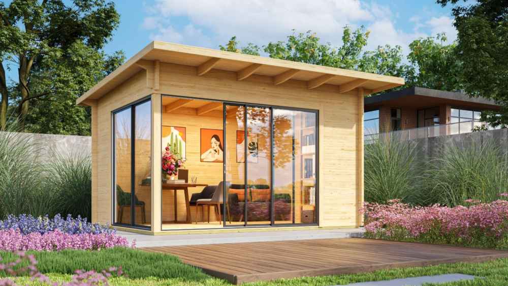 GardenHouse24 USA Starla 44A ALU Garden Room is pictured in a landscaped backyard setup, used as an office space with visible desk, flowers, and artwork inside