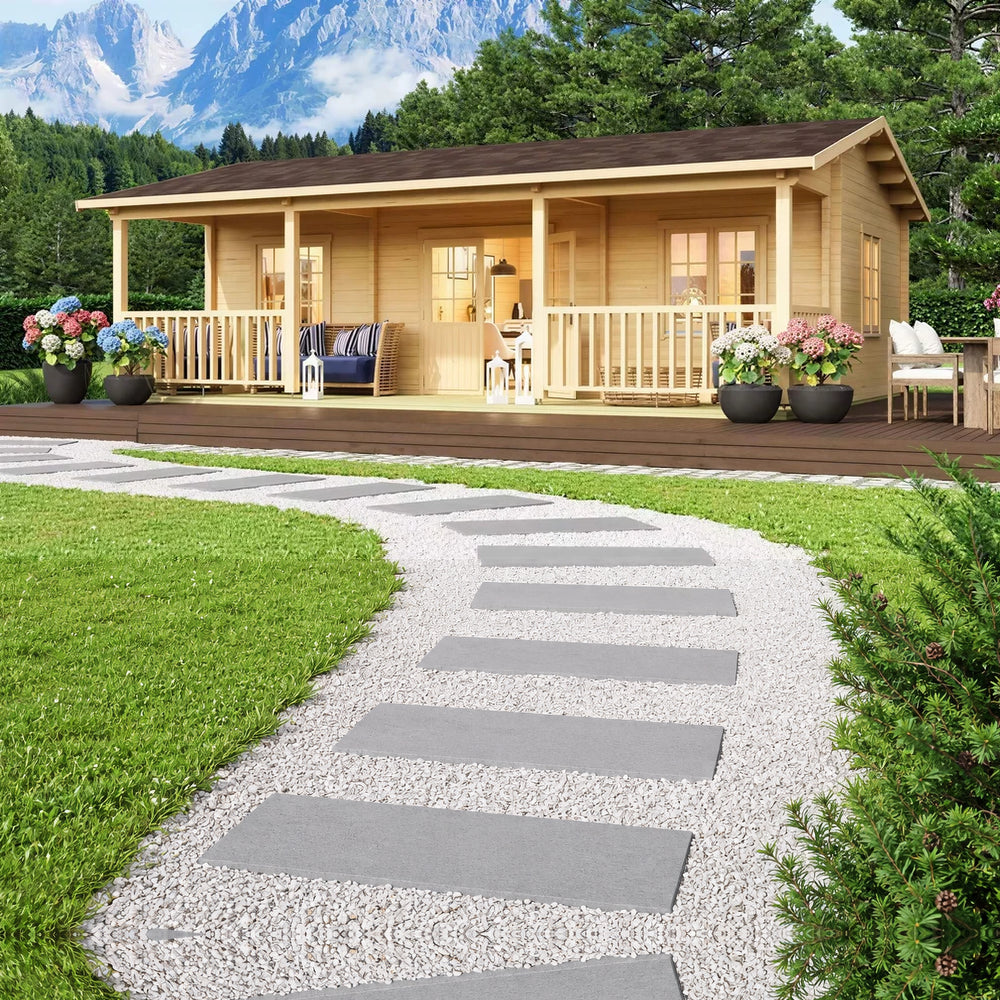 GardenHouse24 USA Barrit 70 Garden Room with a spacious front porch surrounded by potted flowers and mountains in the background