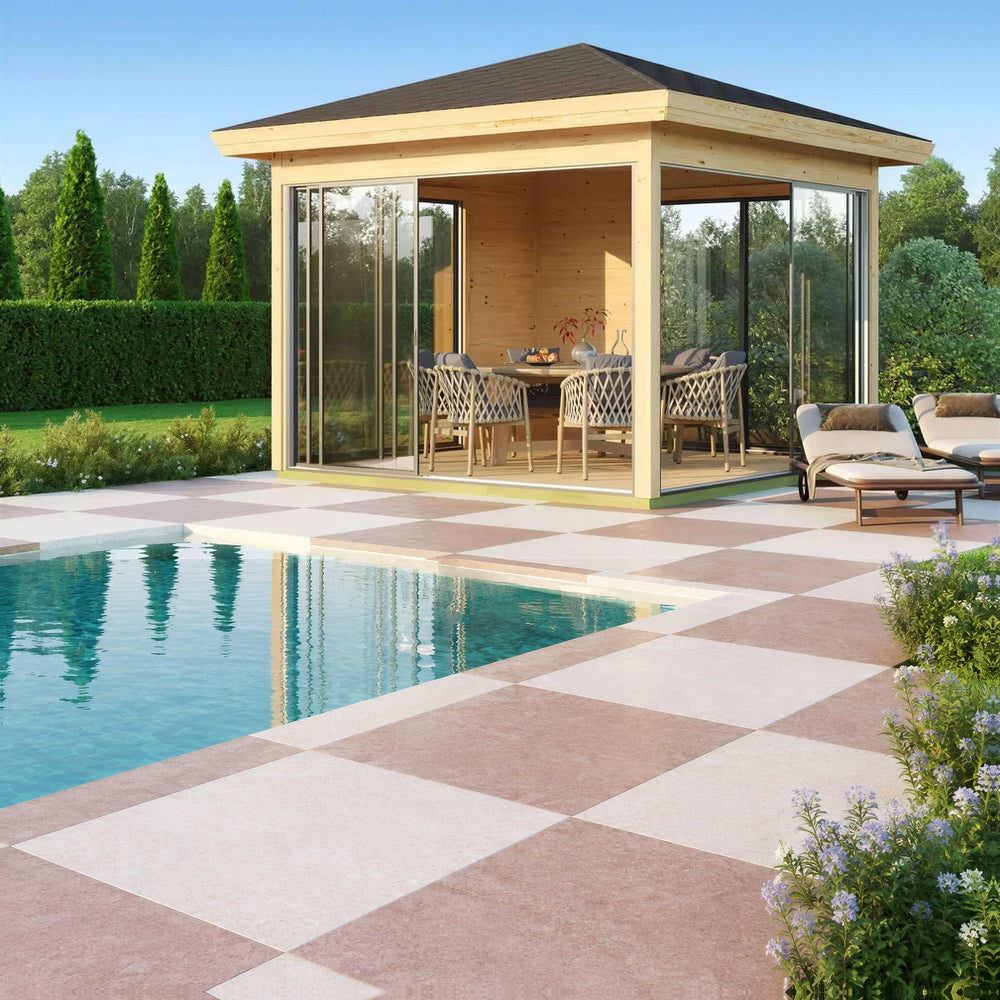 GardenHouse24 USA Glaspavillon ALU 44E ISO Garden Room features a stylish dining setup inside a sunlit glass pavilion near lounge chairs