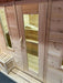 Glass-fronted door of Sawmill Structures Box Sauna revealing the wooden bench seating inside
