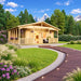 Glostrup 44 wooden garden room with a covered veranda, railings and hanging flower baskets, surrounded by lush landscaping with snow-capped mountains in the background.