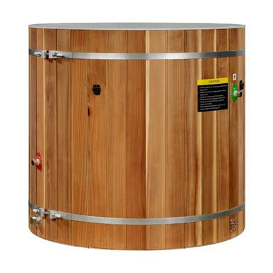 Golden Designs Dynamic Cold Therapy PVC Barrel Cold Plunge stands as a round cedar barrel with two steel bands, side valves and a yellow warning label