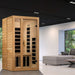Golden Designs Dynamic Gracia 1-2 Person Low EMF Far Infrared Sauna stands in a modern living room beside a gray sofa and large windows