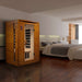 Golden Designs Dynamic Versailles Elite 2 Person Ultra Low EMF Far Infrared Sauna stands in a modern bedroom with a dark wood floor