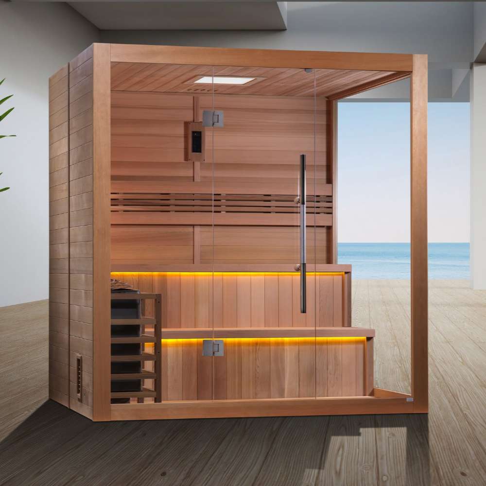 Golden Designs Kuusamo 6 Person Traditional Sauna stands on a gray wood floor in a bright room with a window looking out over the sea