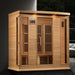 Golden Designs Maxxus 4 Person Near Zero EMF Far Infrared Sauna in Hemlock glows with accent lights in a dark modern room