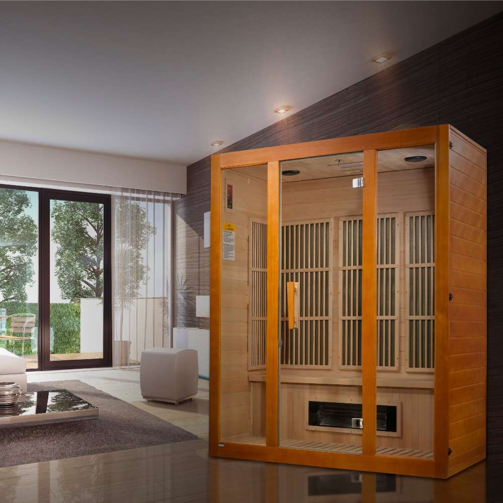 Golden Designs Maxxus Alpine Dual Tech 3 Person Low EMF Far Infrared Sauna stands in a bright living room with tall windows and a white sofa