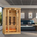 Golden Designs Reserve Edition 2 Person Full Spectrum Sauna with Himalayan Salt Bar stands in a modern living room beside a blue sofa and framed art