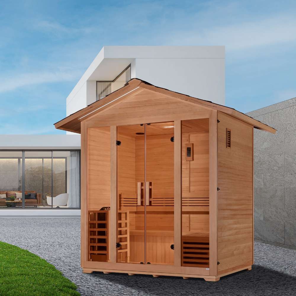 Golden Designs Vorarlberg 5 Person Traditional Outdoor Sauna stands on a gravel patio beside a green lawn and a modern white house
