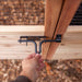 Hand secures the metal latch on the gate of Outdoor Living Today 8×5 Raised Garden Bed, showing how it closes tightly