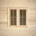 Pair of rectangular wooden windows with four-pane grids set into the pale wood exterior of the Harvest Grand Bungalow.