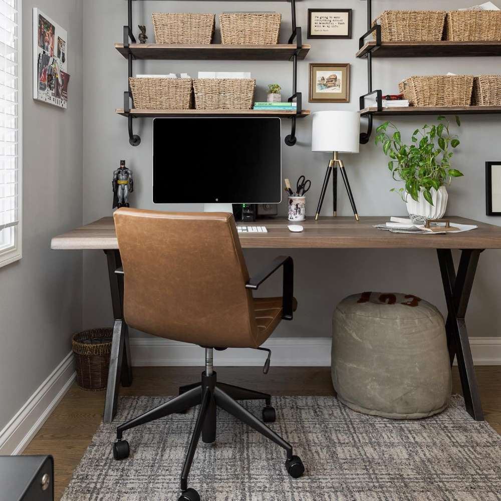 Home office setup featuring Crate & Barrel Graham Brown Office Chair at a wood desk with wall shelving and storage baskets