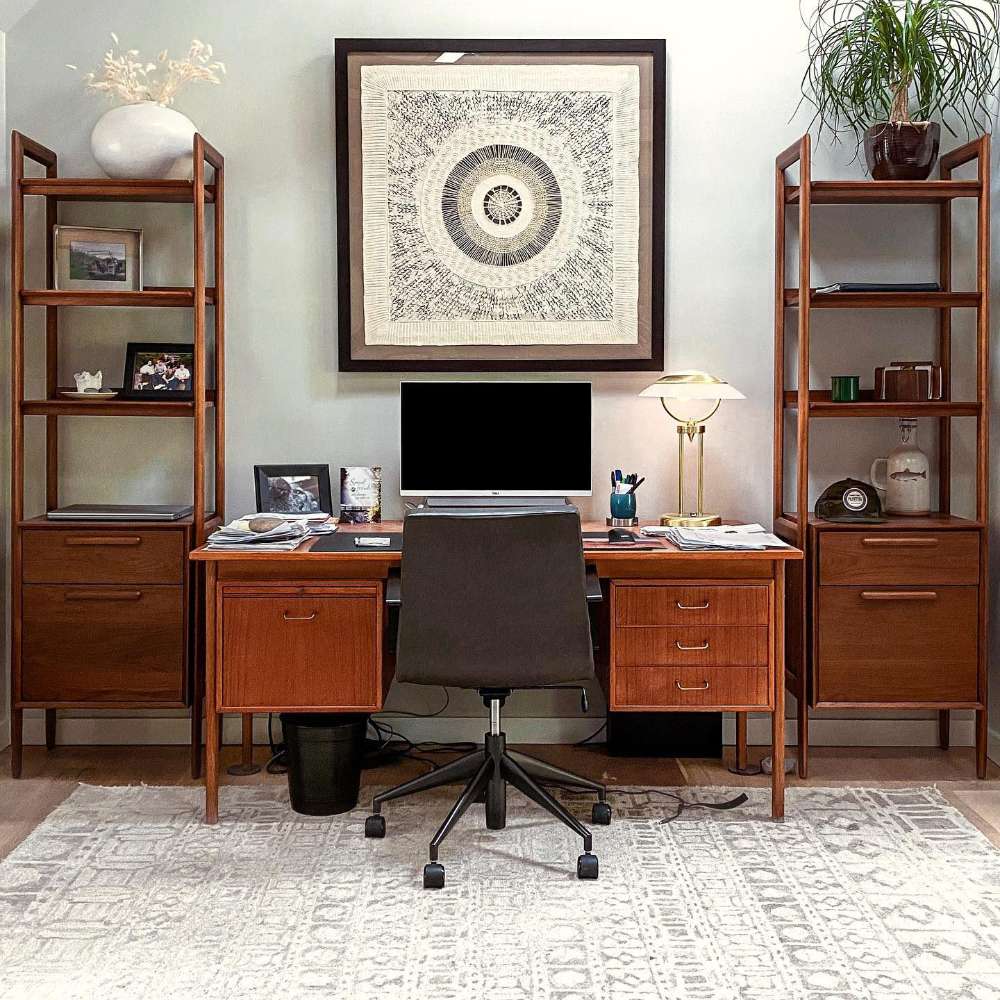 Home office setup featuring two Crate & Barrel Tate Walnut Bookcase File Cabinet units flanking a desk, with open shelves, file storage, and decorative accents