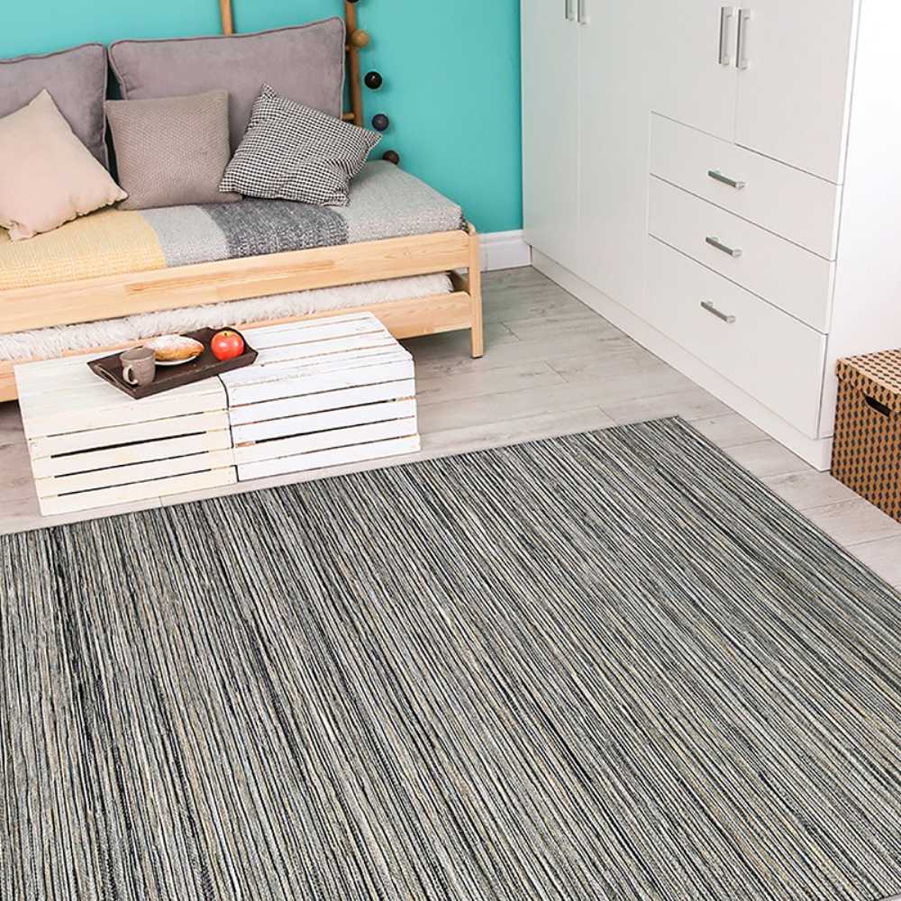 In a cozy room with light wood flooring, the Couristan Cape Indoor/Outdoor Rug - Hinsdale/Light Brown-Silver adds a stylish and textured touch to the floor space