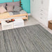 In a cozy room with light wood flooring, the Couristan Cape Indoor/Outdoor Rug - Hinsdale/Light Brown-Silver adds a stylish and textured touch to the floor space