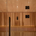 Inside Golden Designs Copenhagen 3 Person Traditional Sauna, tiny star lights dot the cedar ceiling above a black door handle and softly lit backrest boards