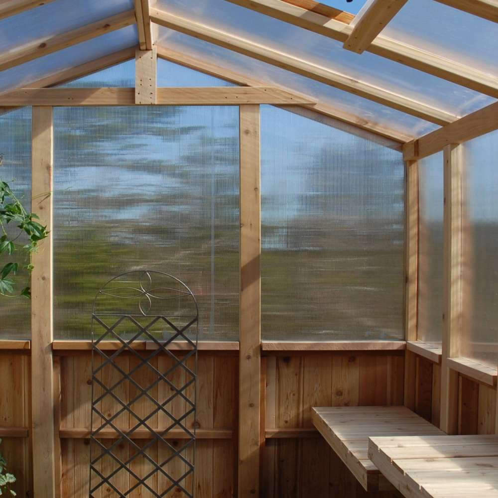 Inside view with wooden shelves and clear panels highlights the 8x8 Outdoor Living Today Western Red Cedar Greenhouse Kit