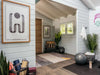 Inside Sawmill Structures The Versa 240 70MM Garden Room, a serene wellness setup features yoga mats, plants, wall art, and a cozy chair