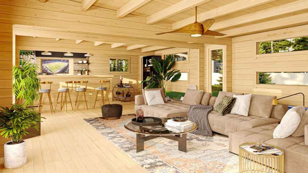 Inside the GardenHouse24 USA Dundee 90A Garden Room, there’s a cozy lounge with a large sectional sofa, bar counter, ceiling fan, and warm wood interior
