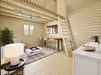 Inside the Sawmill Structures BlueWater Loft 160 38mm Garden Room, there's a compact, modern living space with a loft, ladder, high ceilings, and cozy seating
