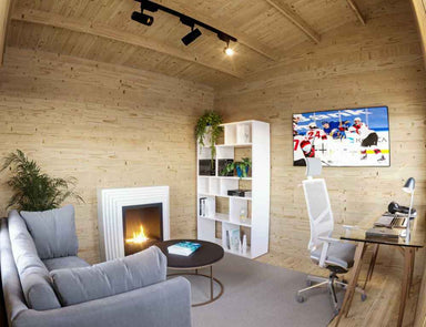 Inside the Sawmill Structures Multi Cube Versa 100 Garden Room, a warm, wooden interior features a comfy gray couch, fireplace, desk, and TV