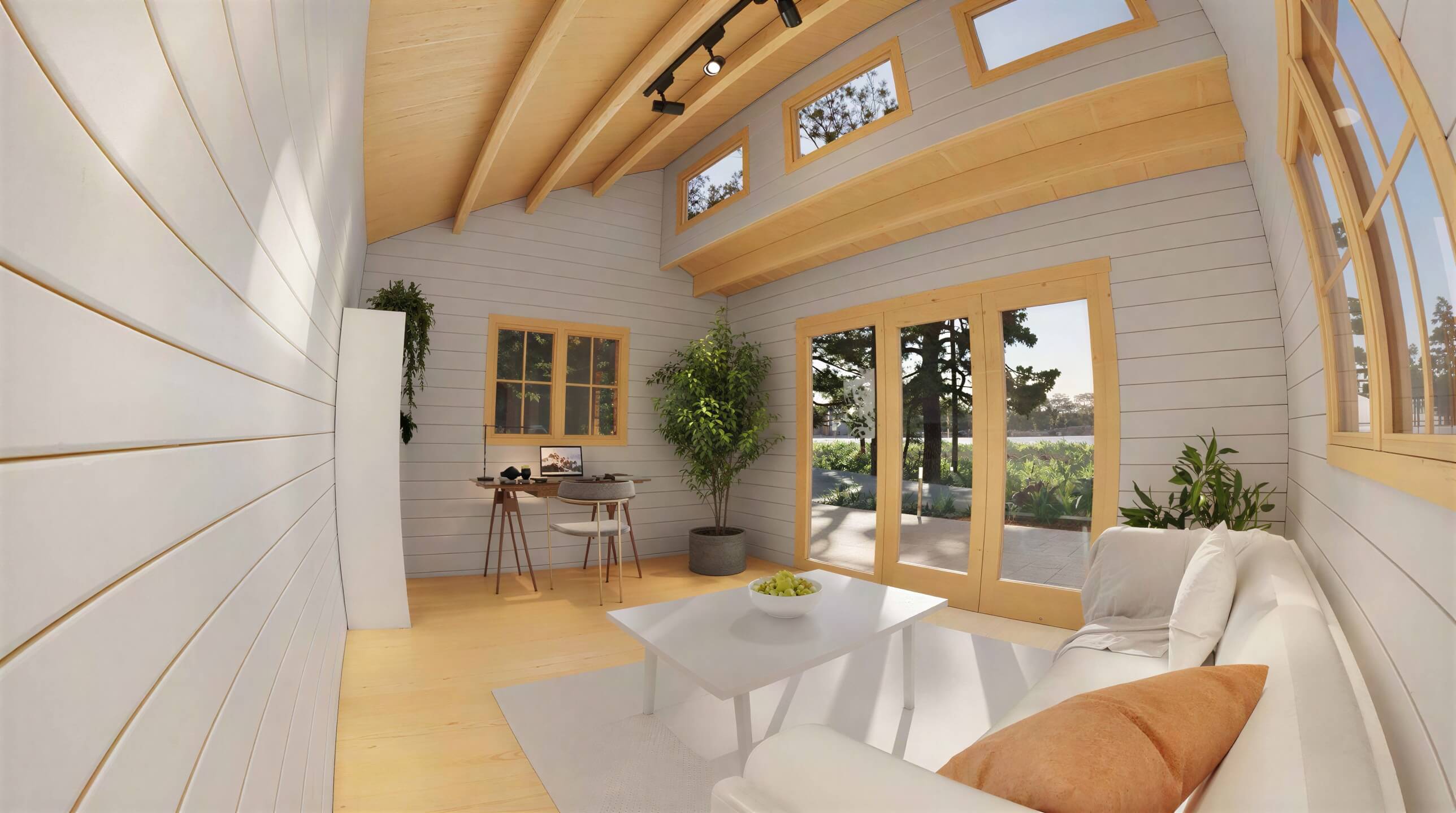Inside the Sawmill Structures The Versa 160 Atrium 70MM Garden Room, a cozy, sunlit living space features a white couch, desk, and tall windows framed by wooden beams