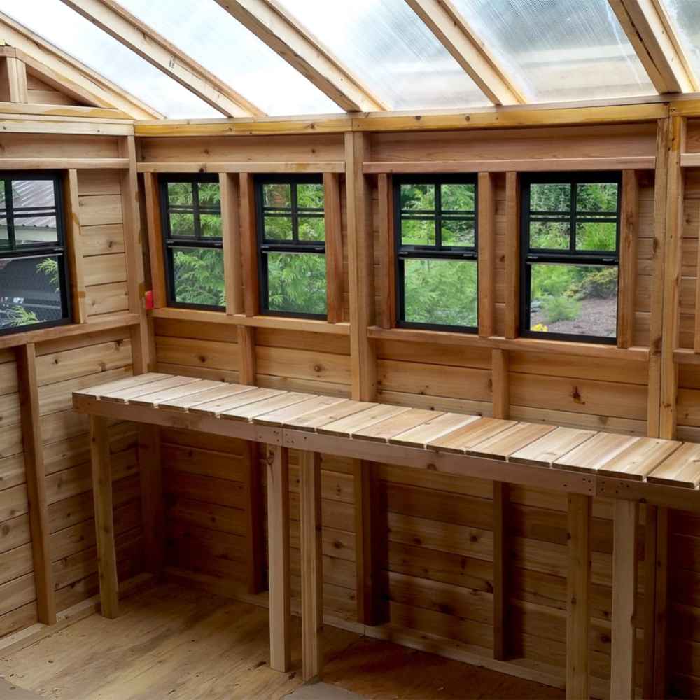 Inside the Outdoor Living Today 12×12 Sunshed Garden Shed, a long wooden workbench runs beneath multiple windows