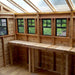 Inside the Outdoor Living Today 12×12 Sunshed Garden Shed, a long wooden workbench runs beneath multiple windows