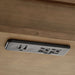 Integrated USB ports and power outlets under Crate & Barrel Tate Walnut Bookcase Desk with Outlet for easy device charging