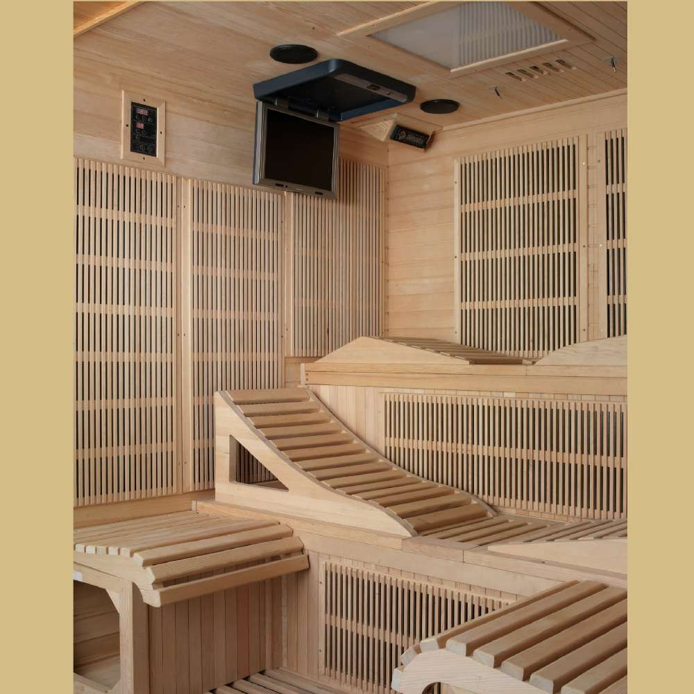 Interior view of Golden Designs Dynamic Monaco Elite 6 Person Ultra Low EMF Far Infrared Sauna showing reclining benches, carbon panels and a ceiling-mounted media player