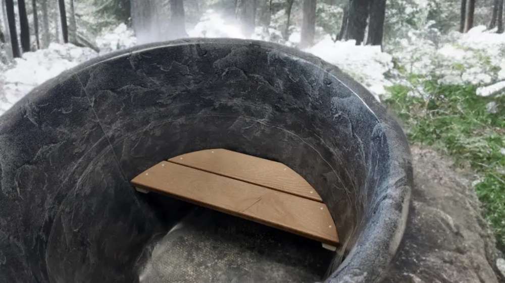 Interior of Sawmill Structures Chiller Plunge shows a smooth stone-like surface with a small wooden bench
