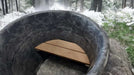 Interior of Sawmill Structures Chiller Plunge shows a smooth stone-like surface with a small wooden bench