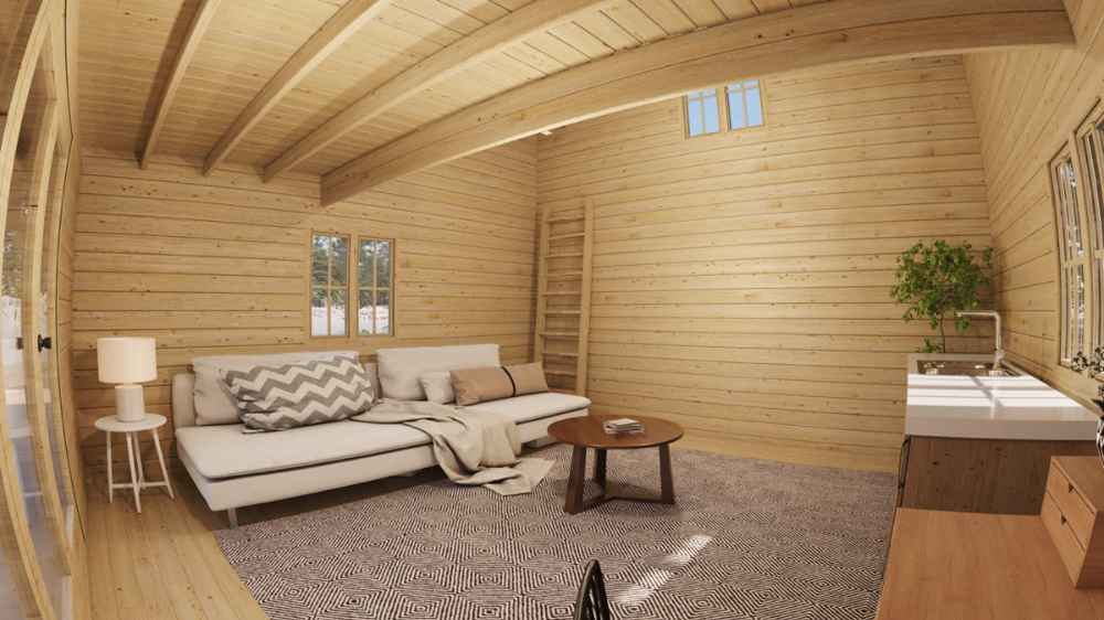 Interior view of Sawmill Structures The Northwood Grand DD 70mm Garden Room displays a sofa, kitchen space, large rug, and ladder leading to the loft