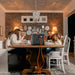 Jackery Explorer 2000 V2 Portable Power Station sits on a dining table powering household devices while a family shares a meal