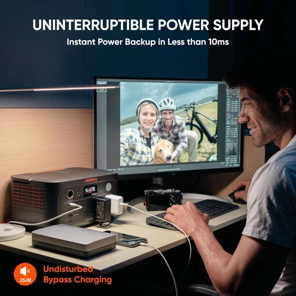Jackery Explorer 500 v2 Portable Power Station powers a desktop setup during a blackout, highlighting its fast UPS backup capability