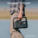 Person carries Jackery Explorer 500 v2 Portable Power Station outdoors, showing its lightweight and compact size for easy transport