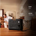 Jackery HomePower 2000 Plus v2 Power Station powers a home setup with text showing a 60W LED TV for 25 hours and an 850W portable AC for 150 minutes