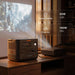 Jackery HomePower 2000 Plus v2 Power Station powers a projector in a cozy room, with text showing a 55W heated blanket for 24 hours and a 100W projector for 16 hours