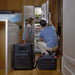Jackery HomePower 3600 Plus Battery Pack connected indoors beside a power station while a family uses a refrigerator