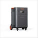 Jackery Solar Generator Explorer 5000 Plus + SolarSaga 500X x 2 portable power station shown at an angle, featuring a large black body, orange accents, wheels, and multiple power outlets on the front