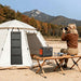 Jackery SolarSaga 40 Air Solar Panel hangs on a camping tent while charging a portable power station beside a person taking photos outdoors
