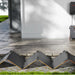 Jackery SolarSaga 500X Solar Panel is unfolded on the ground outside a home, connected to a backup power system for solar charging