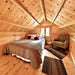 Cozy Jumbo Grand Loft 130 SD bedroom with a full-size bed, gray bedding, accent pillows, a green armchair and a sloped pine ceiling.