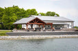 Lakeside view of Brookside Timber Frame Combolan Estate Pavilion presents a picturesque setting with its grand timber design
