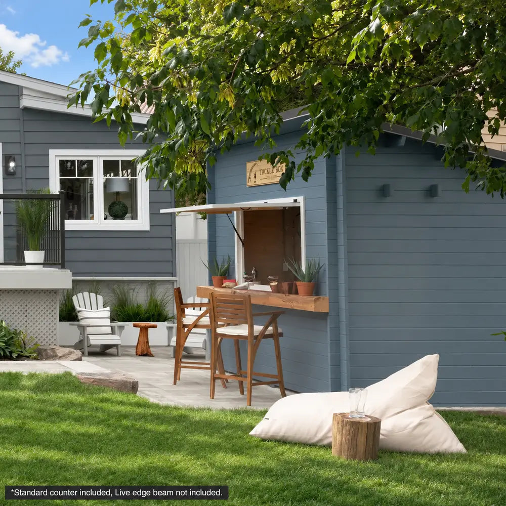 Angled view of the blue Lakeside Versa Cabana 67 with an open bar window, wooden stools, white Adirondack chairs, and a bean bag on the lawn.