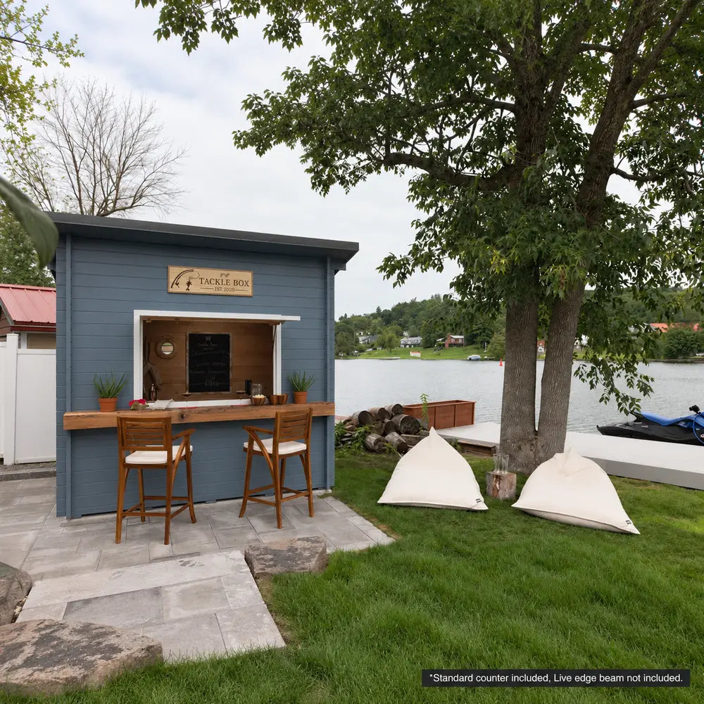 Blue Lakeside Versa Cabana 67 beside a lake with an open serving window, wooden counter, bar stools, and white bean bag chairs.