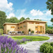 A landscaped garden surrounds the GardenHouse24 USA Harbord 70 Garden Room, featuring an outdoor seating area and blooming flowers in the foreground