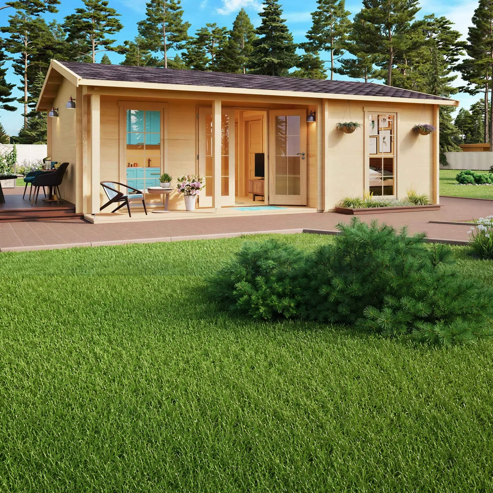 Set in a lush forested area, the GardenHouse24 USA Lilja 90 Garden Room glows warmly with large glass doors, potted plants, and soft lighting